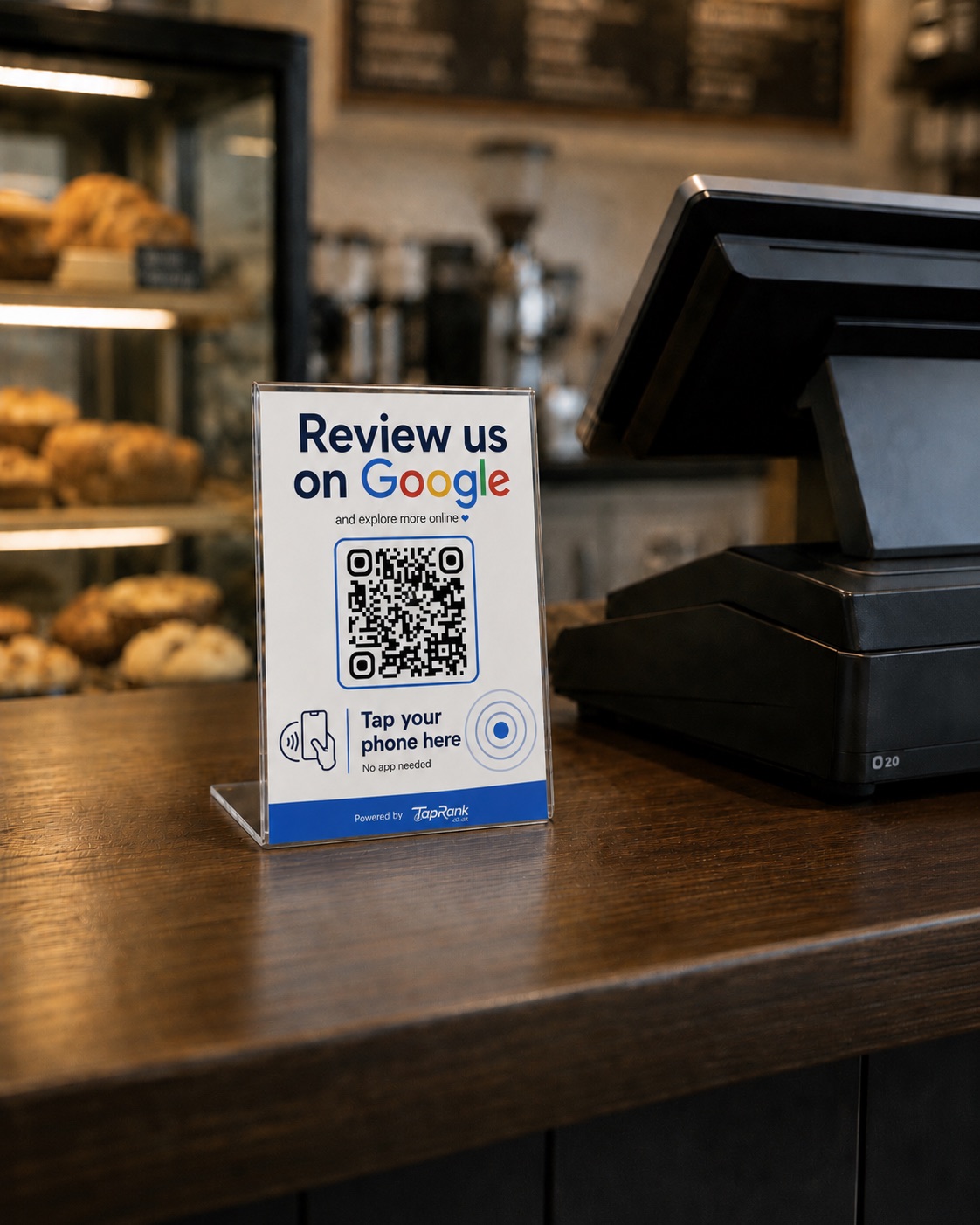 TapRank NFC and QR review stand placed on a cafe counter beside a till